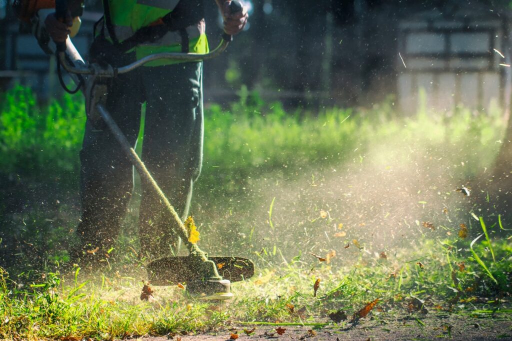 Landscaper weed eating